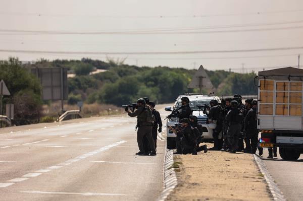 Members of the Israeli army take position at Zikim area following a rocket attack from Gaza.