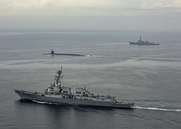 The Ohio-class ballistic-missile submarine USS Kentucky (SSBN 737) proceeds on the surface to Busan for a port visit while escorted by Arleigh Burke-class guided-missile destroyers USS John Finn (DDG 113) and USS Ralph Johnson (DDG 114) on Tuesday. (Photo - US Navy)